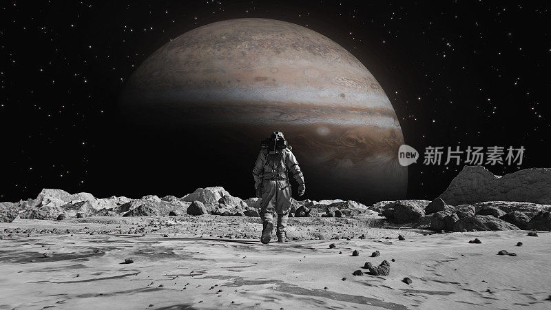 勇敢的宇航员穿着宇航服在月球上自信地走向布满岩石的木星。第一位登上月球表面的宇航员。人类的重大时刻。先进技术，太空探索/旅行，殖民概念。